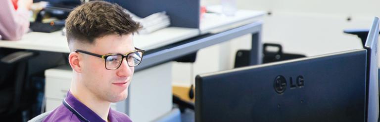A person working at a desk in a Newark Beacon office.