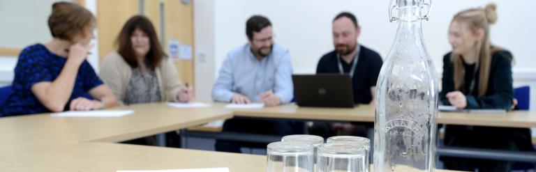 A group of people attending a meeting in one of the Newark Beacon meeting rooms.
