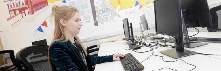 A person working at a desk in a Newark Beacon office